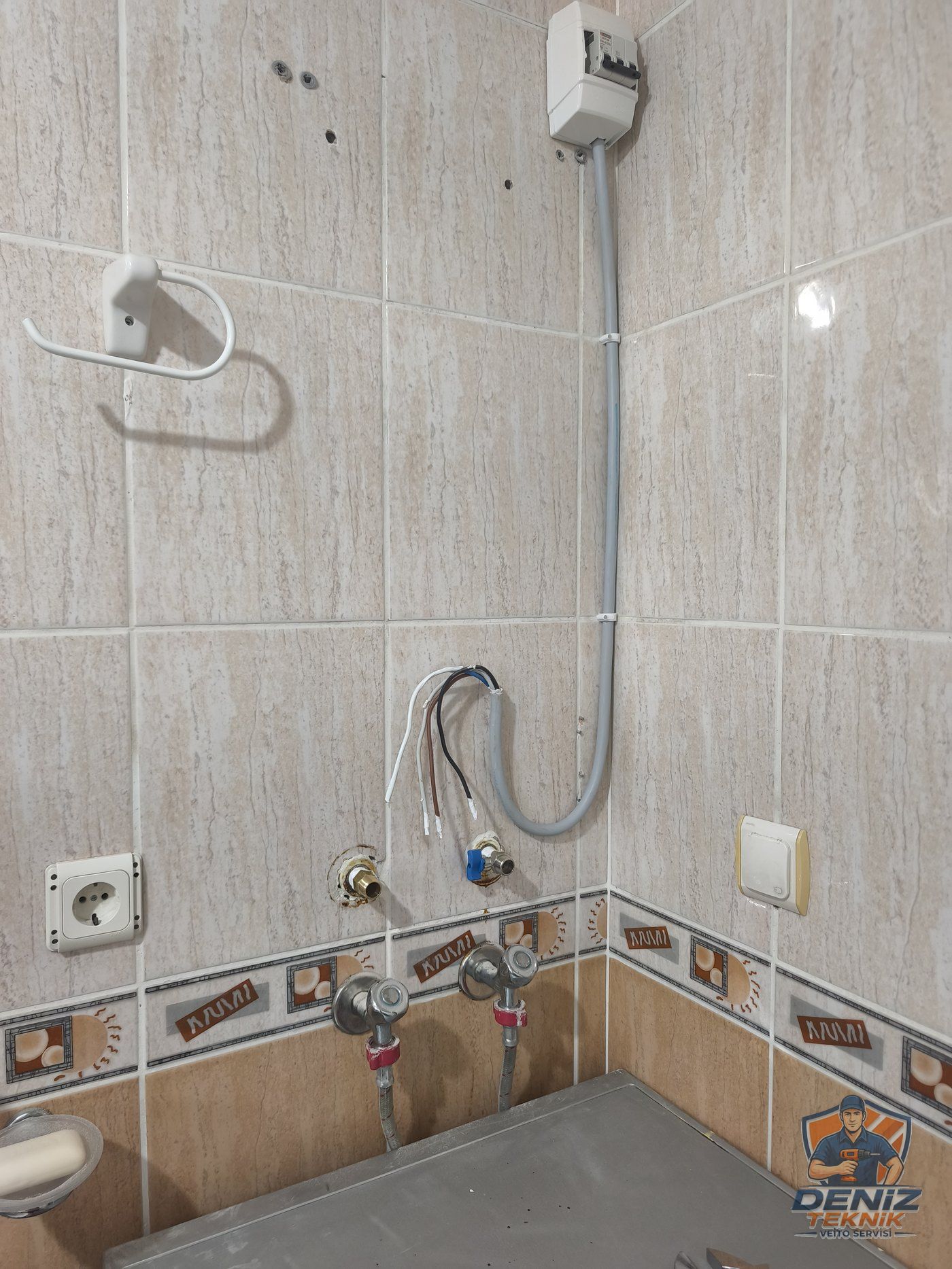Banyo duvarında kör tapa uçları, sıva üstü kanalla gelen elektrik hattı ve ayrı sigorta kutusu — ani su ısıtıcı montajı öncesi